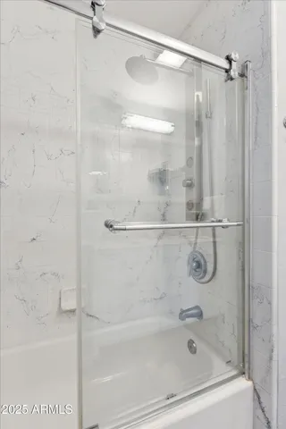 a bedroom with bed and window