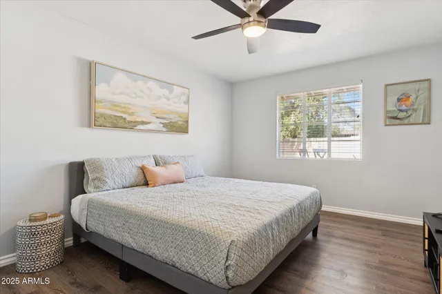 a bedroom with a bed and a painting on the wall