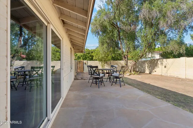 a view of a patio with table and chairs