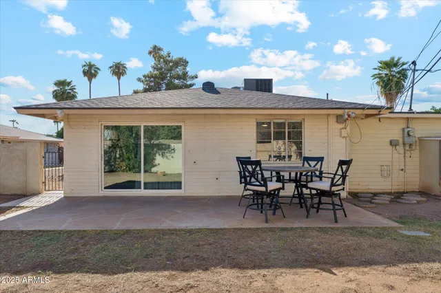 a view of a backyard with a patio and fire pit