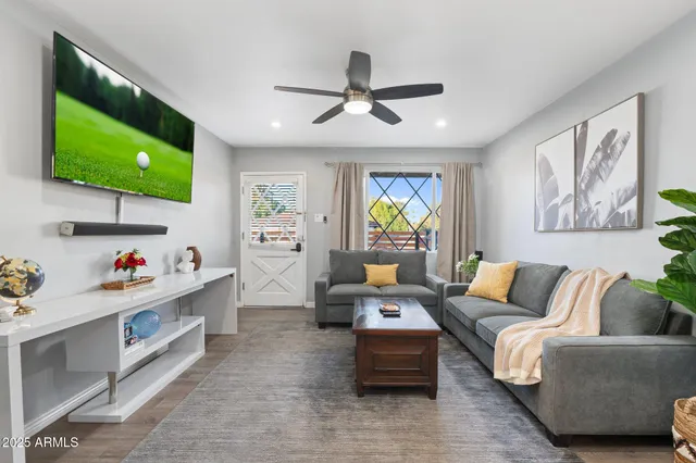 a living room with furniture and a flat screen tv