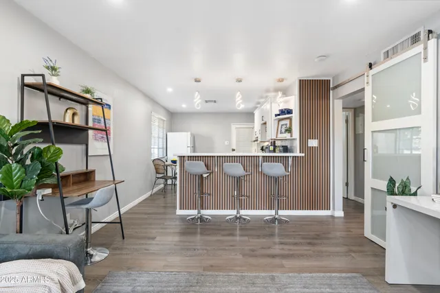 a living room with furniture and kitchen view