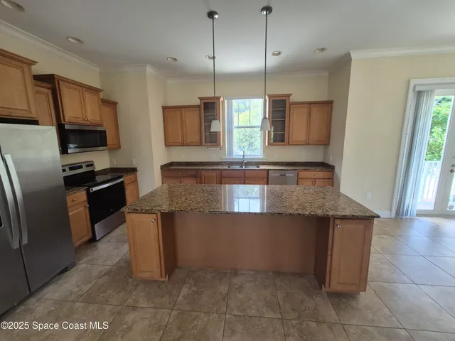 a kitchen with stainless steel appliances granite countertop a sink and a microwave