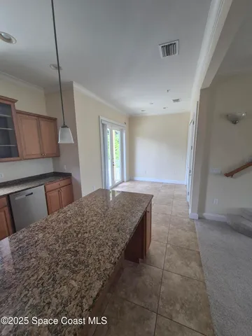 a spacious bedroom with a bed and a dresser