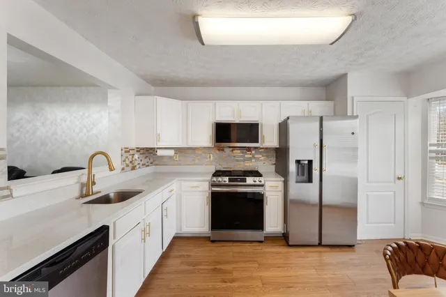a kitchen with a sink stove and refrigerator