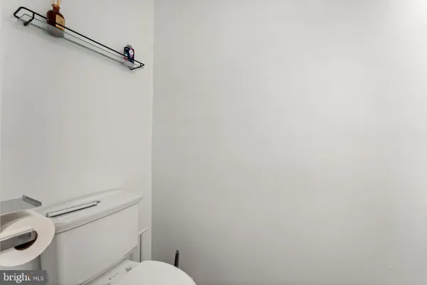 a white toilet sitting next to a shower