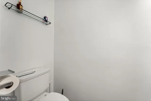 a white toilet sitting next to a shower