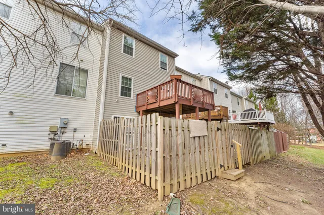 a view of a house with a wooden fence