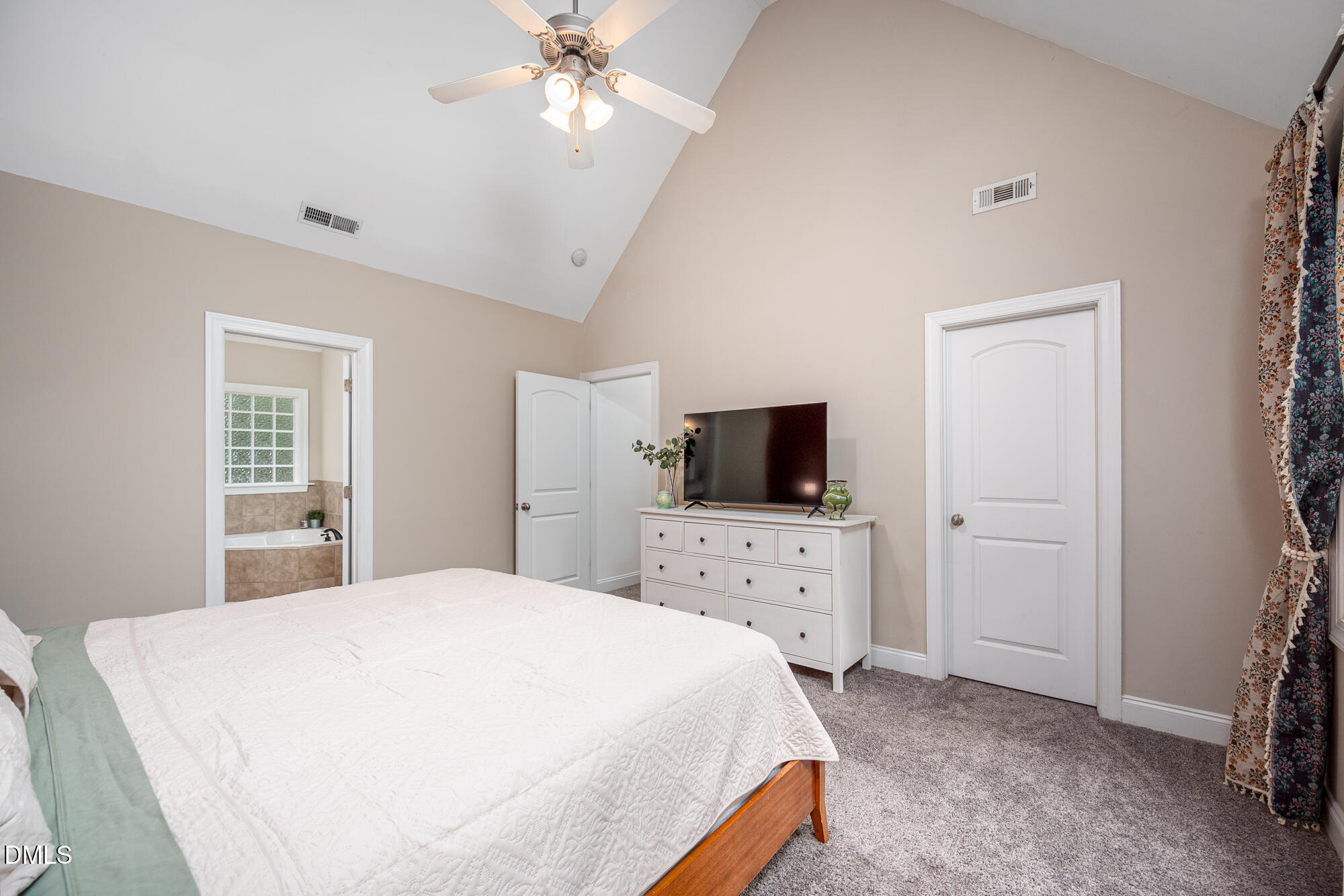 726 Ruth Circle Fuquay-Varina, NC 27526 - Photo 26 of 61 a bedroom with a bed and a flat screen tv