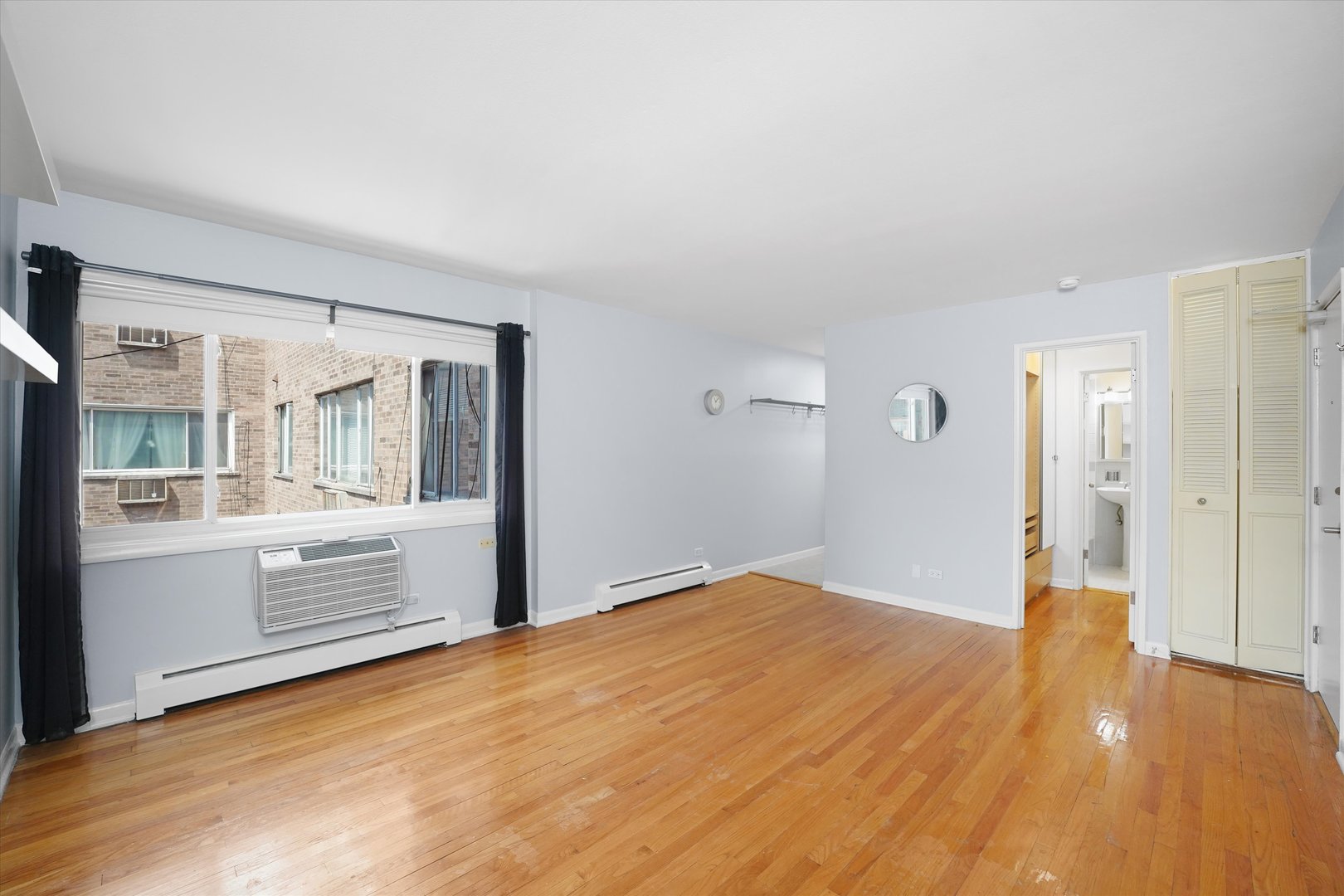 7120 North Sheridan Road, Unit 404 Chicago, IL 60626 - Photo 2 of 21 a view of an empty room and window