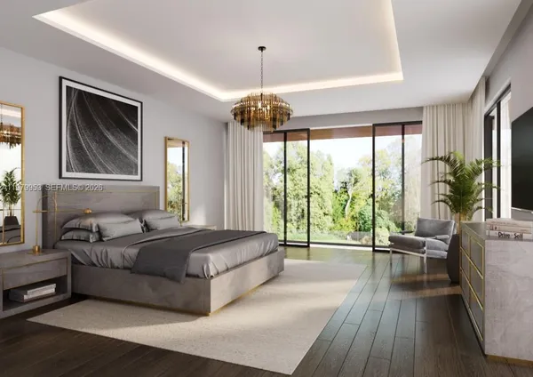 a bedroom with a large bed and a chandelier