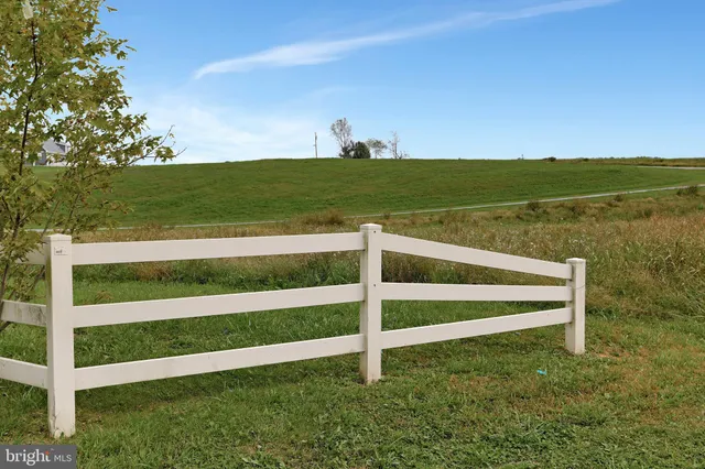 a view of a field with an ocean view