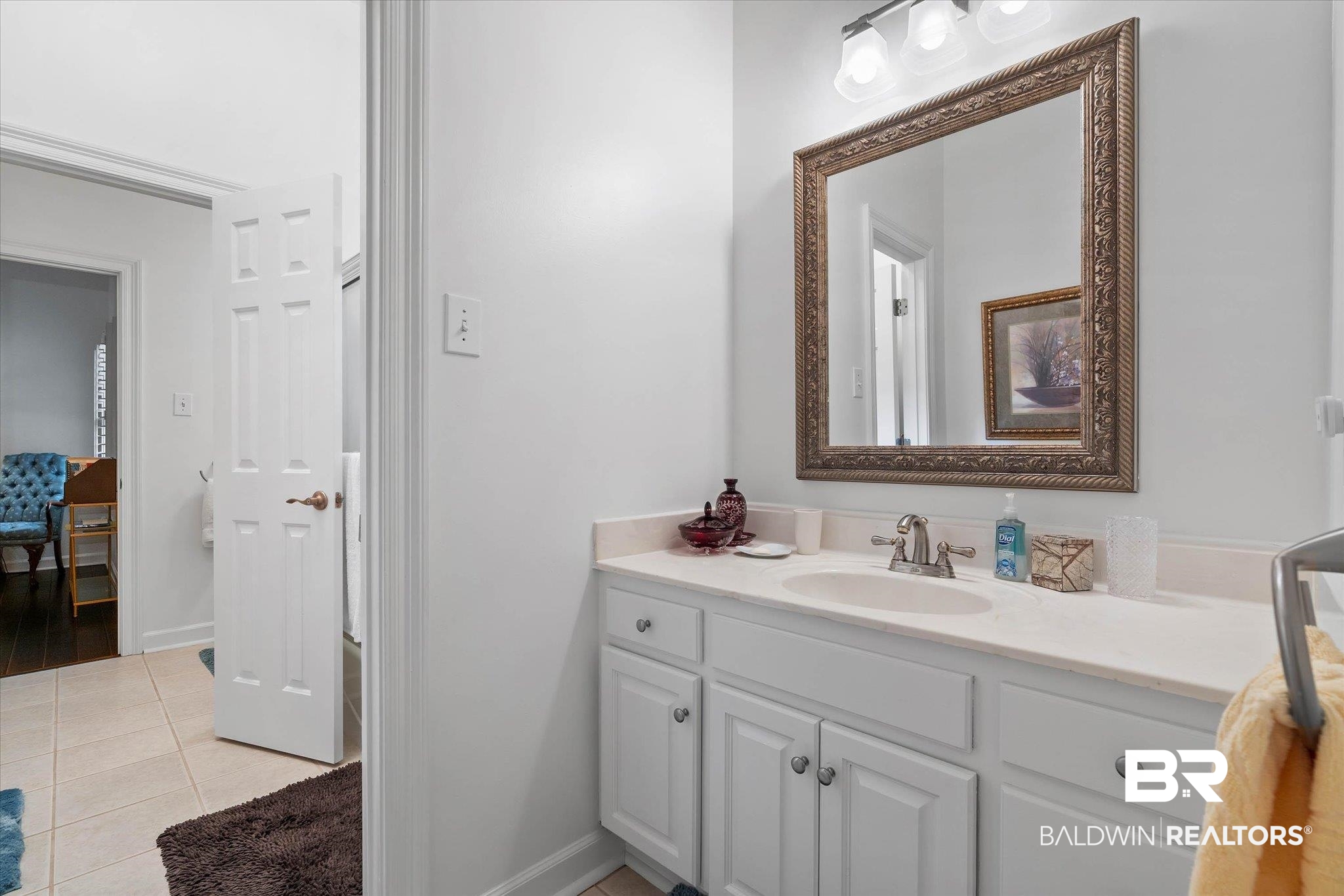 136 Old Mill Road Fairhope, AL 36532 - Photo 23 of 36 Bathroom vanity with a polished countertop, integrated sink, and brushed nickel faucet