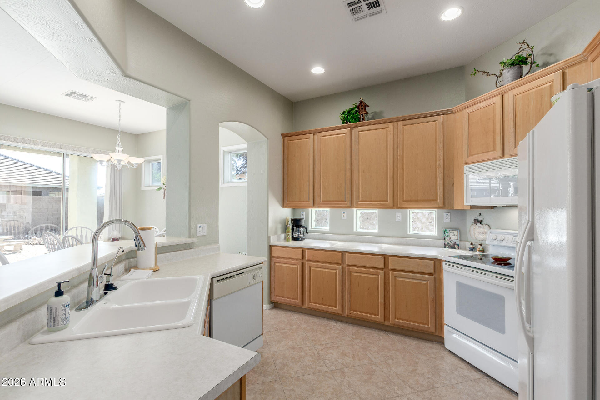 3553 East Washington Avenue Gilbert, AZ 85234 - Photo 12 of 30 a large white kitchen with a sink and cabinets
