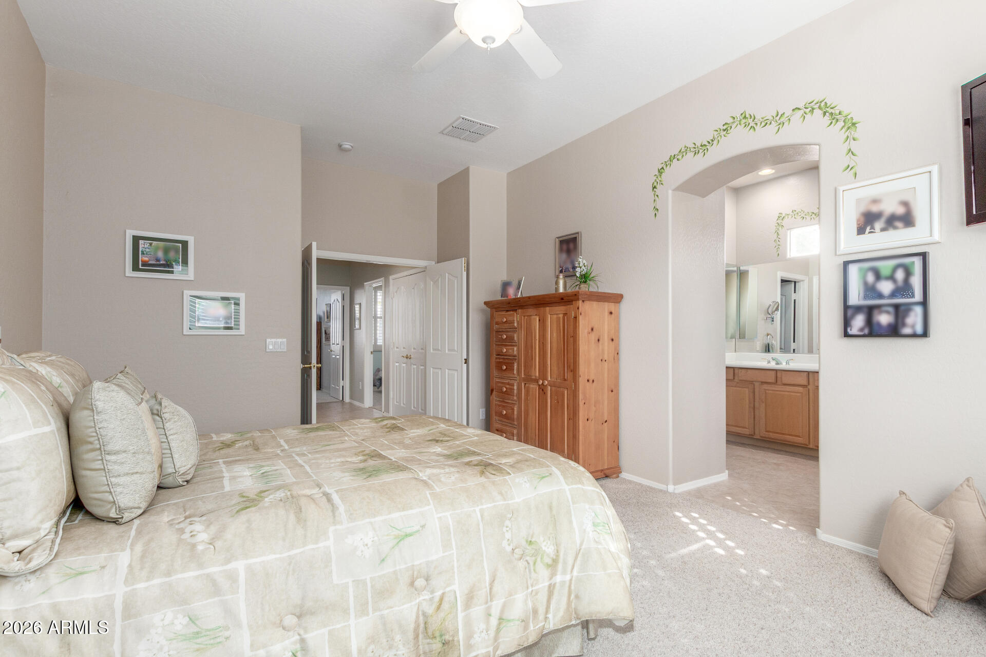 3553 East Washington Avenue Gilbert, AZ 85234 - Photo 16 of 30 a spacious bedroom with a bed and a chandelier