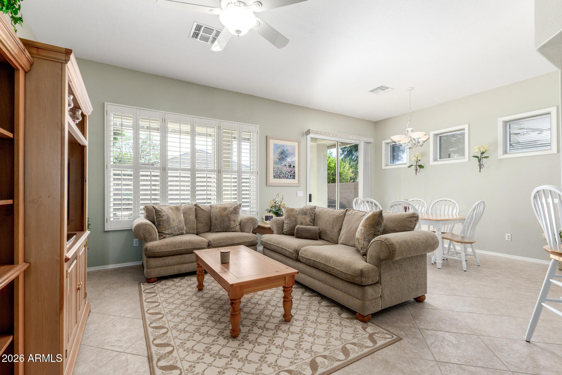 3553 East Washington Avenue Gilbert, AZ 85234 - Photo 6 of 30 a living room with furniture a large window and a table