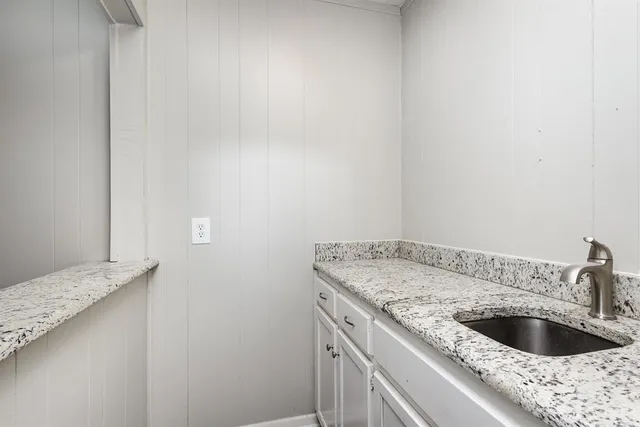 a kitchen with a sink and cabinets