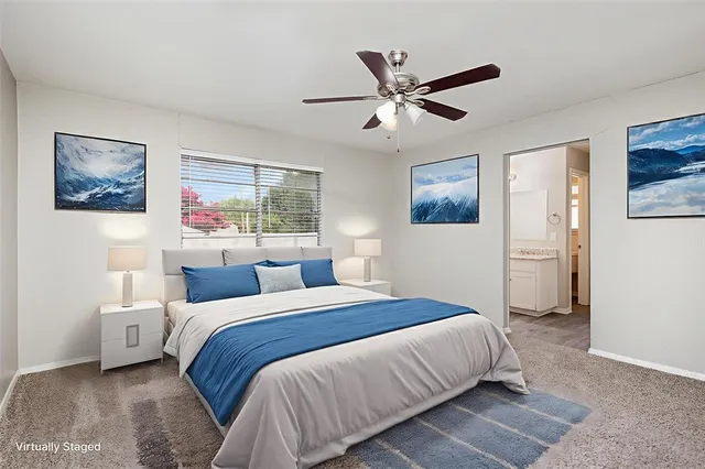 a bedroom with a large bed and a chandelier