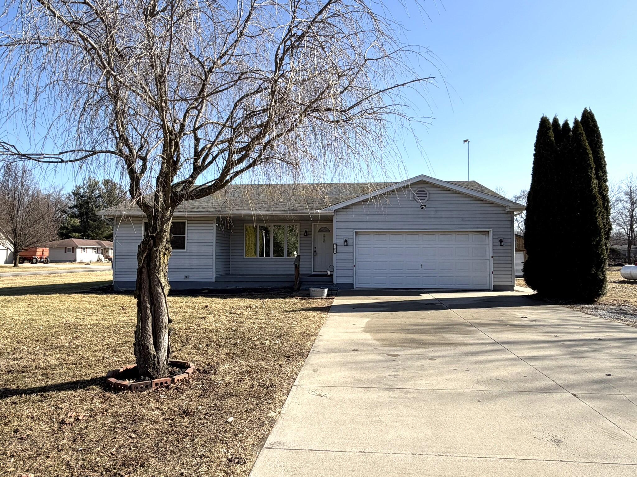9103 Estates Drive Demotte, IN 46310 - Photo 1 of 35 a house with trees in front of it