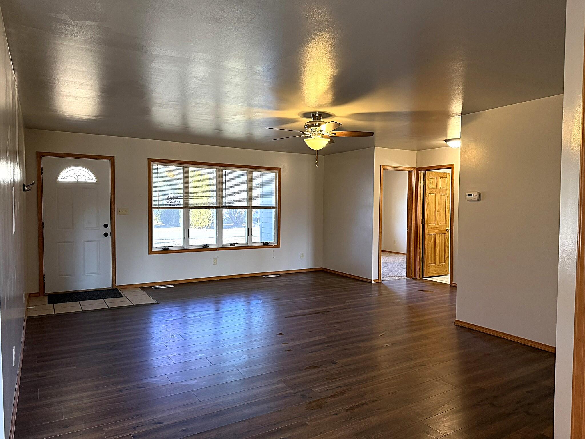 9103 Estates Drive Demotte, IN 46310 - Photo 11 of 35 a view of an empty room with wooden floor and a window