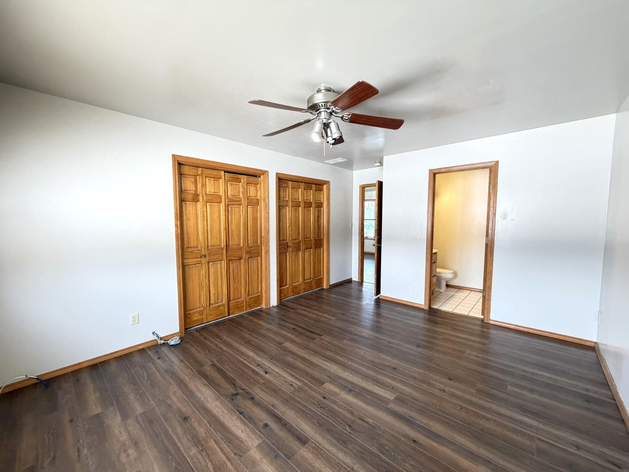 9103 Estates Drive Demotte, IN 46310 - Photo 23 of 35 a view of an empty room with wooden floor and a ceiling fan