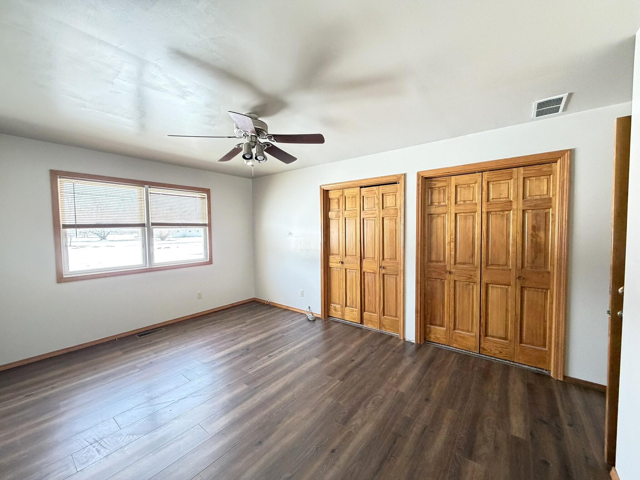 9103 Estates Drive Demotte, IN 46310 - Photo 24 of 35 a view of an empty room with a window and wooden floor