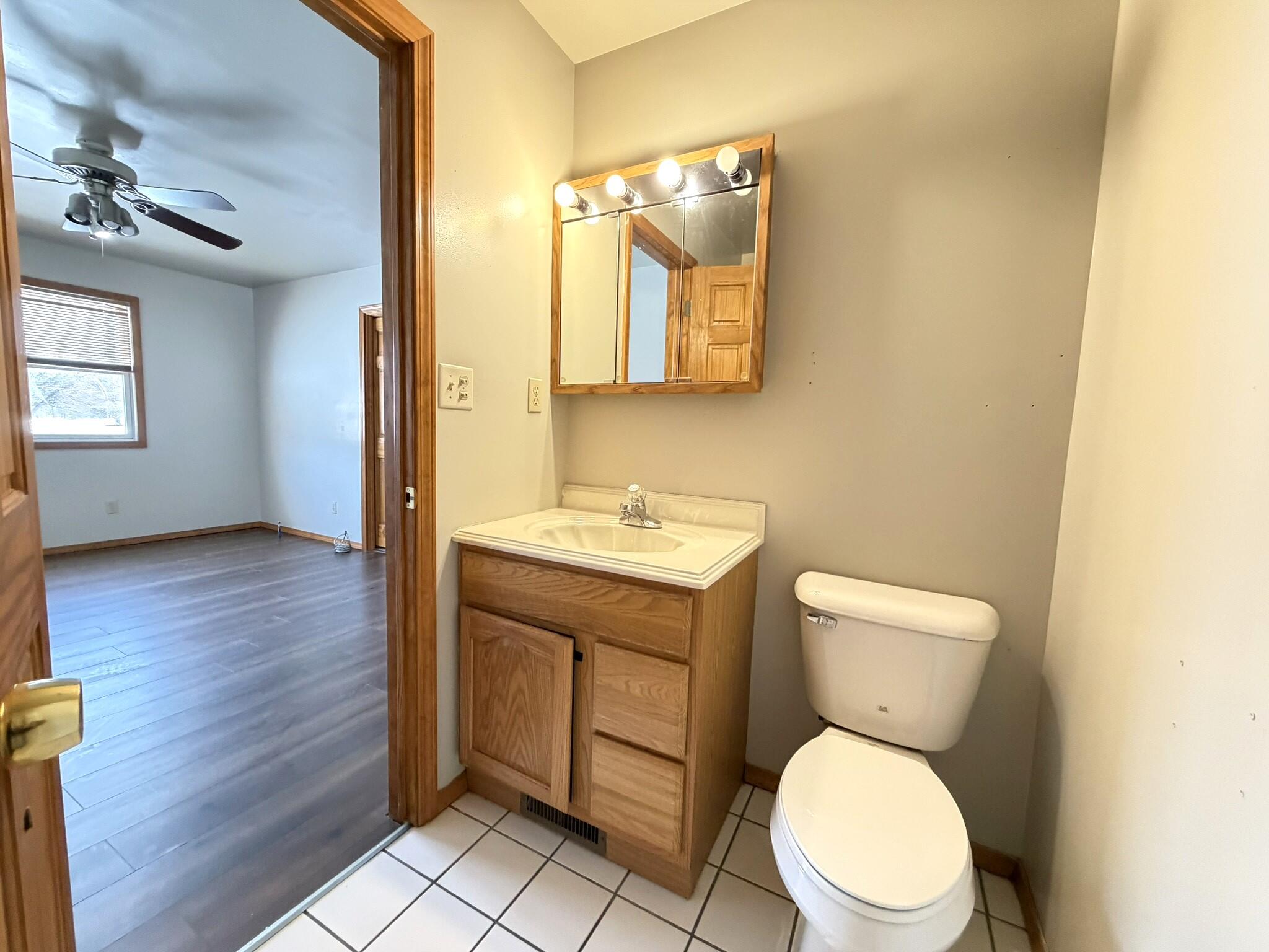 9103 Estates Drive Demotte, IN 46310 - Photo 26 of 35 a bathroom with a toilet a sink and mirror