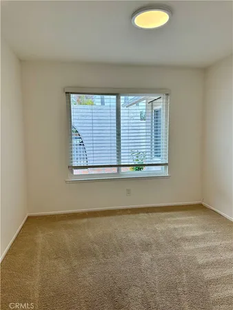 an empty room with a mirror and vanity