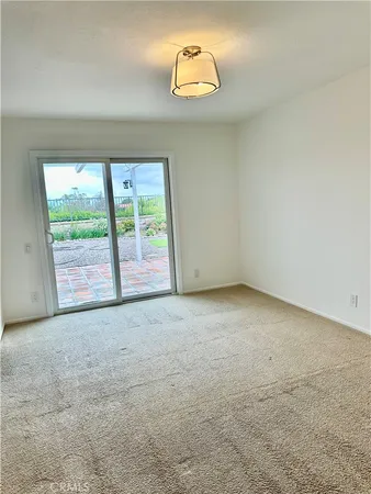 an empty room with windows and outdoor view