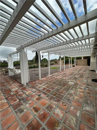 a view of a garden with houses in the background