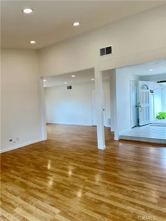 a view of a kitchen with a sink and wooden floor