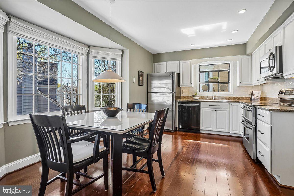 7801 Blue Jasmine Court Springfield, VA 22153 - Photo 15 of 61 a view of a dining room with furniture and wooden floor