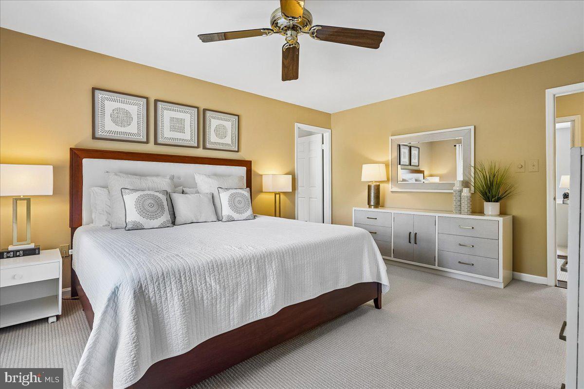 7801 Blue Jasmine Court Springfield, VA 22153 - Photo 24 of 61 a bedroom with a bed and a chandelier