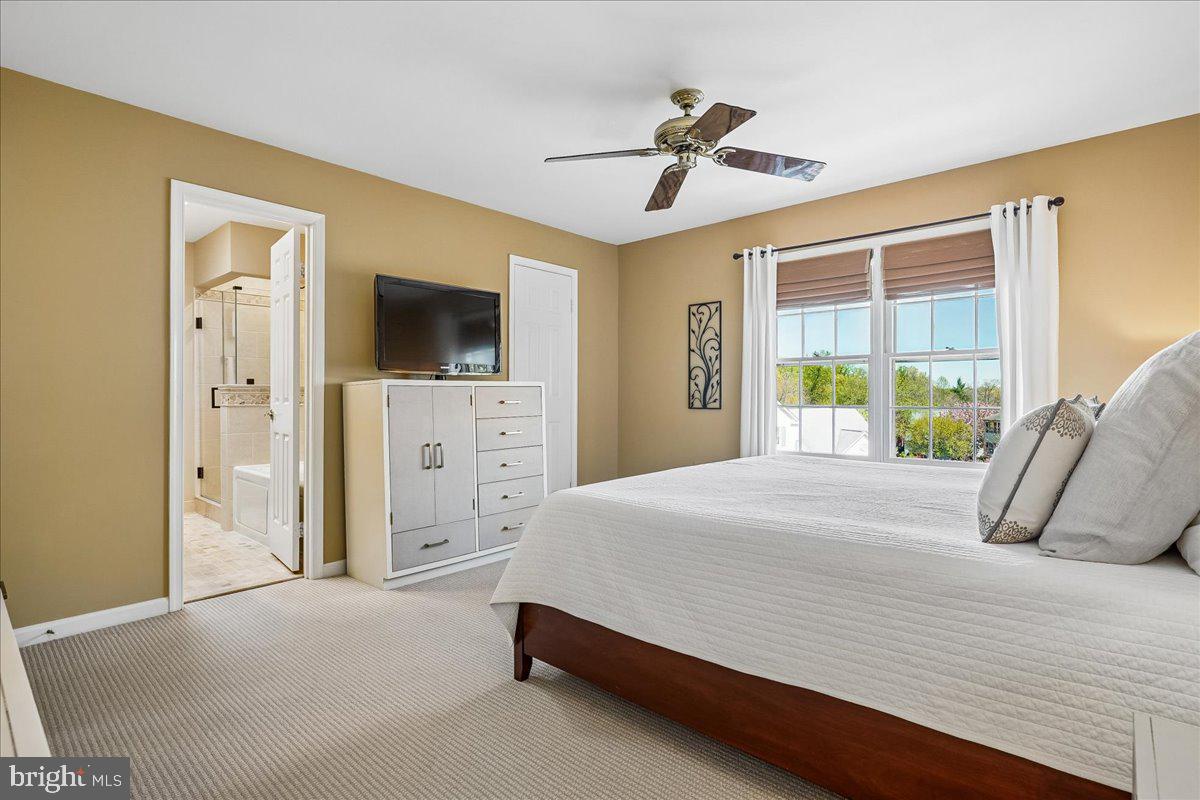 7801 Blue Jasmine Court Springfield, VA 22153 - Photo 25 of 61 a bedroom with a bed and a flat tv screen on dresser