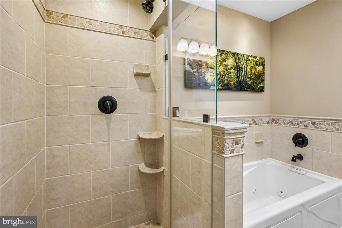 7801 Blue Jasmine Court Springfield, VA 22153 - Photo 27 of 61 a bathroom with a sink and mirror