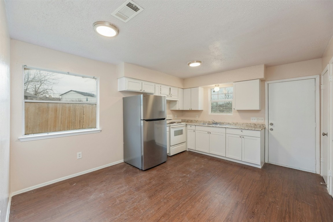 8412 Garcreek Circle Austin, TX 78724 - Photo 11 of 40 Unit A provides a lovely eat-in kitchen with space for a dining table alongside a picture window.