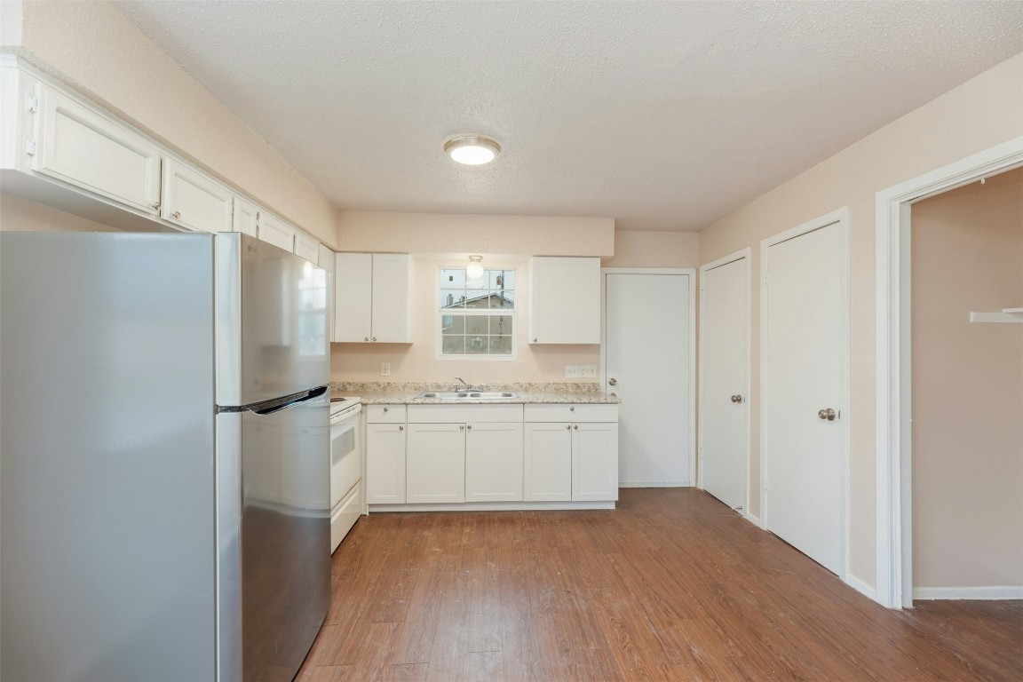 8412 Garcreek Circle Austin, TX 78724 - Photo 13 of 40 Access the backyard area from the back door off the kitchen, with a window over the sink that overlooks the expansive yard behind the units.