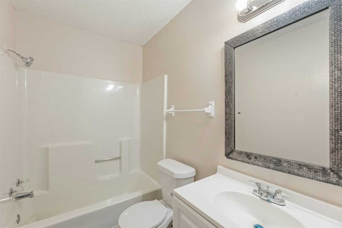 8412 Garcreek Circle Austin, TX 78724 - Photo 20 of 40 The full bathroom in Unit A comes with a single vanity, stylish mirror, and a shower/tub combo. Ready to use as is or update to a modern tub or walk-in shower at your leisure.
