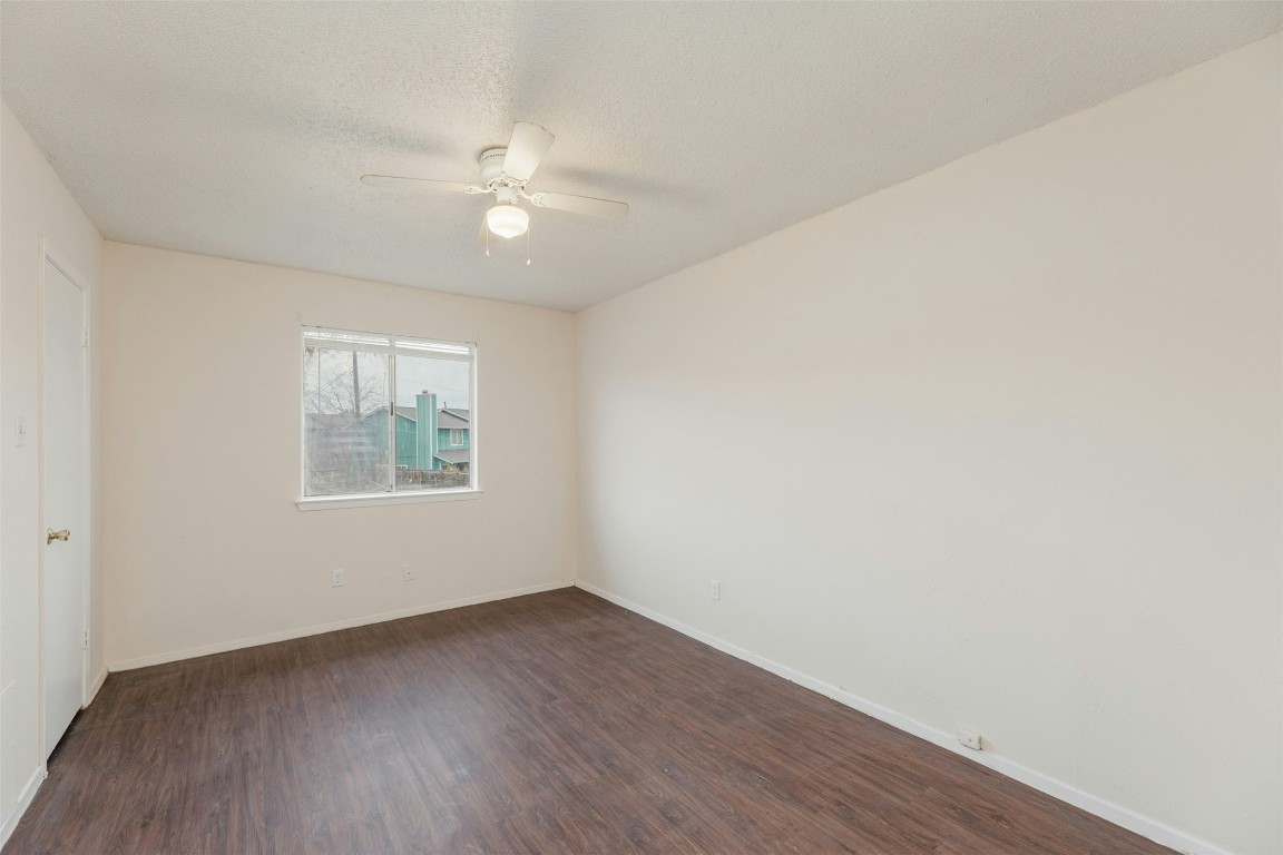 8412 Garcreek Circle Austin, TX 78724 - Photo 32 of 40 The bedrooms feature vinyl plank flooring, ceiling fans, and closet storage.