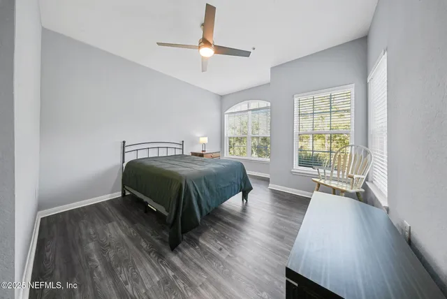 a bedroom with a bed and a large window