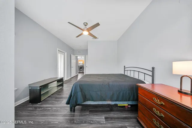 a bedroom with a bed and a chandelier