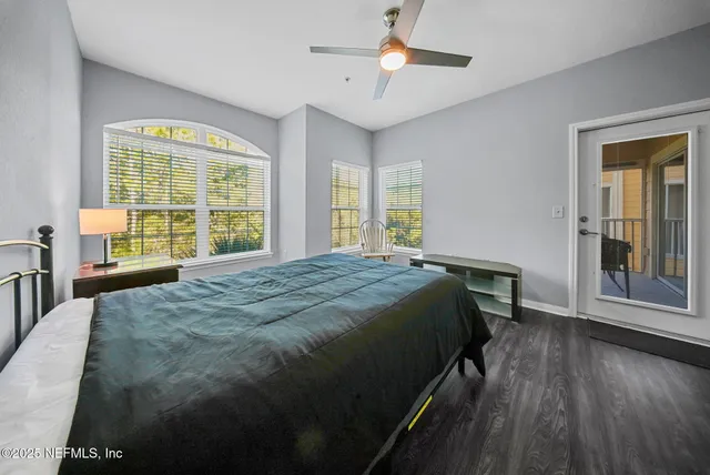 a bedroom with a bed and a large window