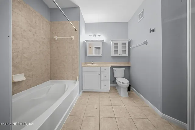 a bathroom with a bathtub sink mirror and toilet