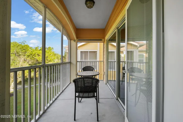 a view of a chair and table on the deck