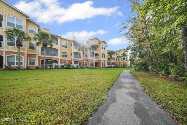 an aerial view of a house with a garden and trees
