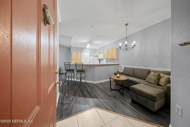 a living room with furniture and a chandelier