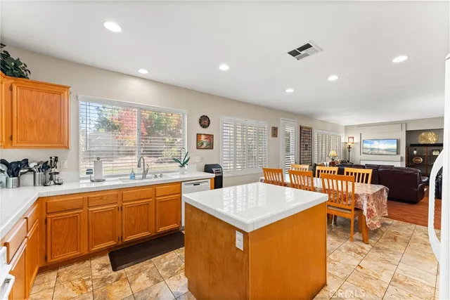 a large dining hall with stainless steel appliances granite countertop a sink and cabinets