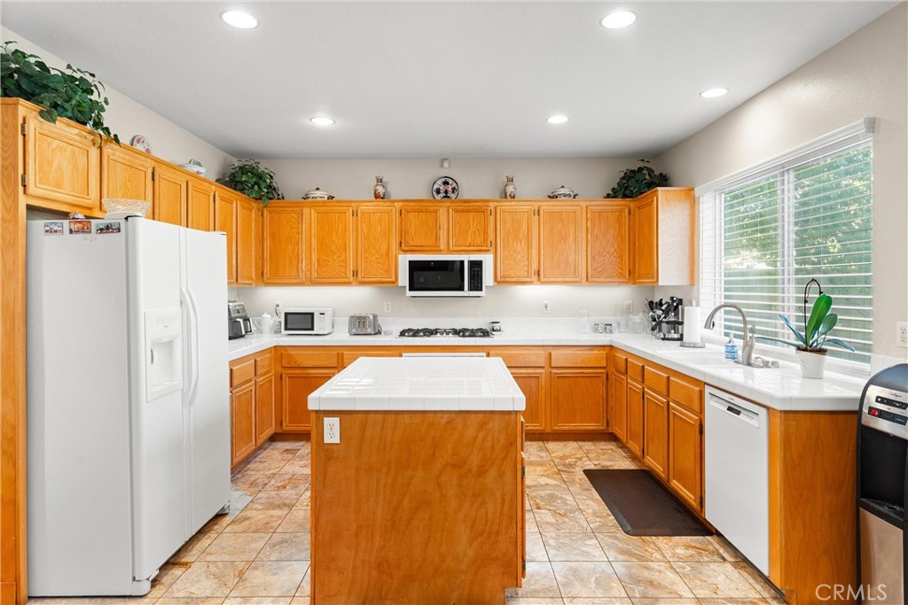 8705 Running Springs Drive Anaheim, CA 92808 - Photo 16 of 37 a kitchen with stainless steel appliances granite countertop a refrigerator sink and cabinets