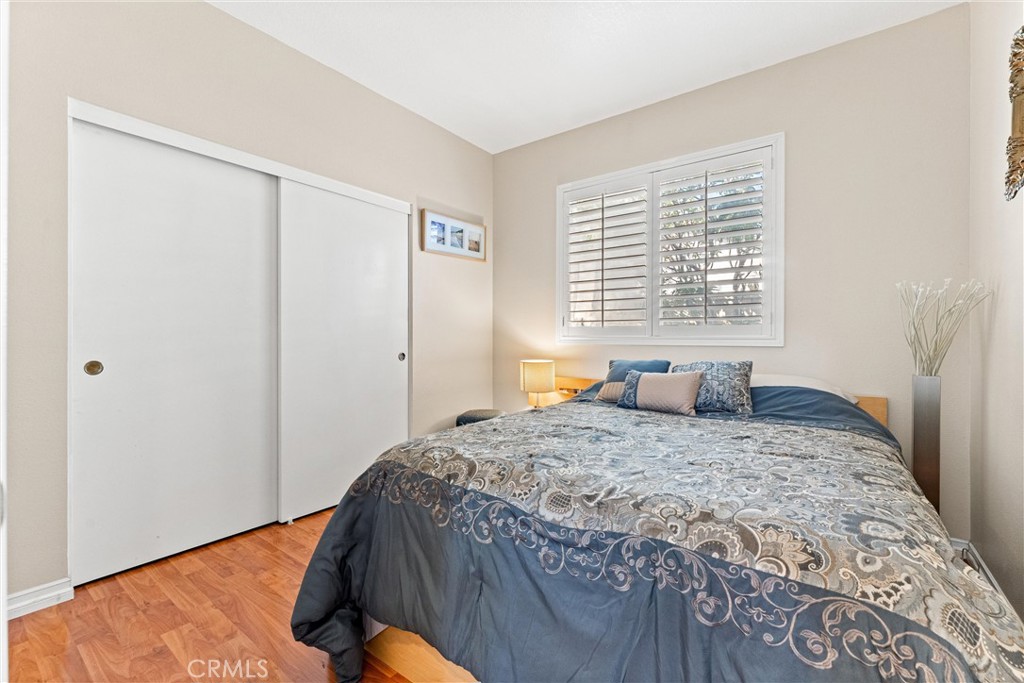 8705 Running Springs Drive Anaheim, CA 92808 - Photo 19 of 37 a bedroom with a bed and a window with chair
