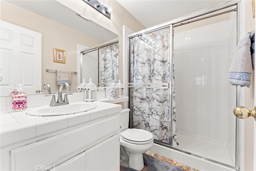 8705 Running Springs Drive Anaheim, CA 92808 - Photo 22 of 37 a bathroom with a sink toilet and shower